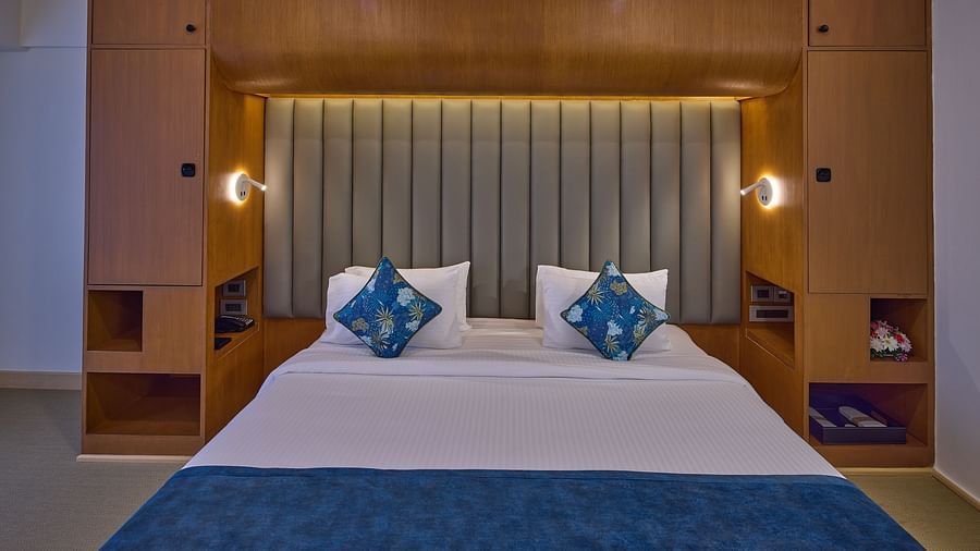 a double bed and nightstands in The Grand Premier King Sea View at Grand Continent, Mahabalipuram